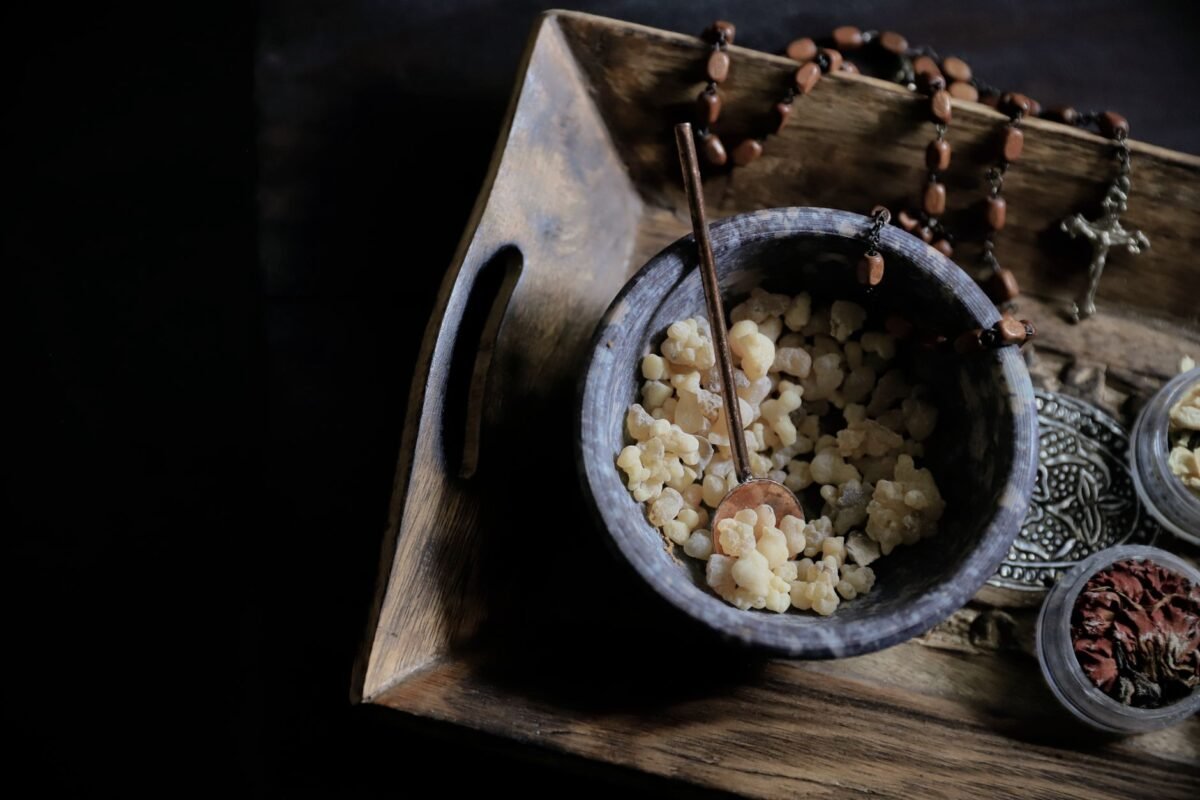 aromatic incense and religious artifacts on wooden tray